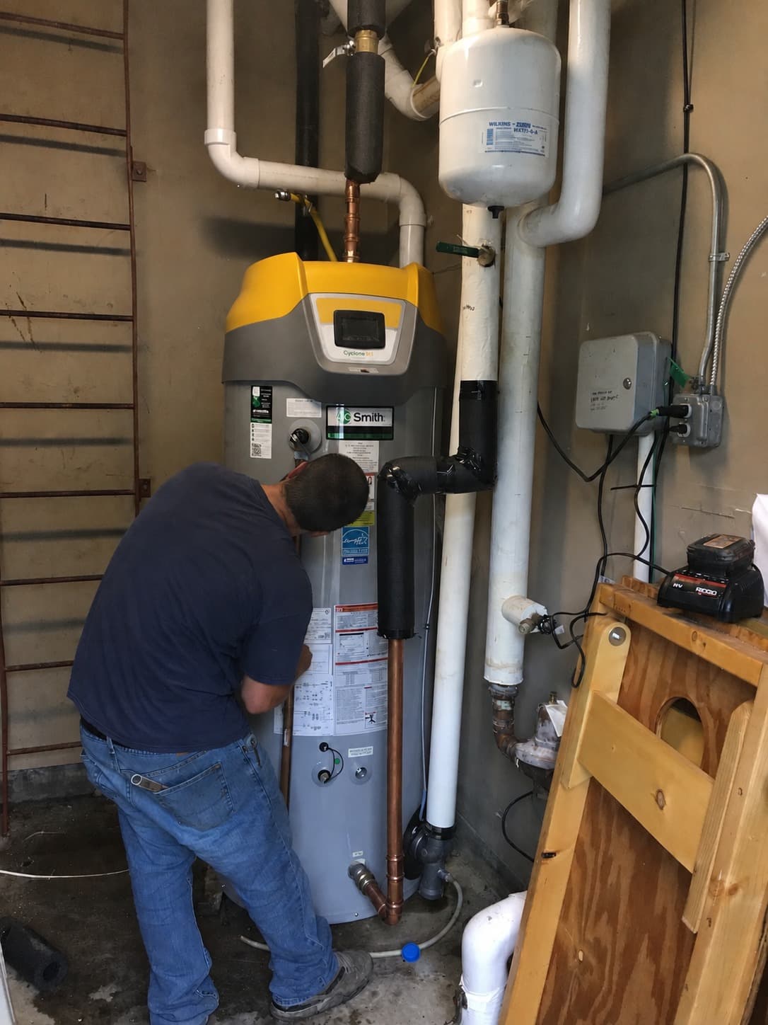 Technician inspecting a residential gas water heater